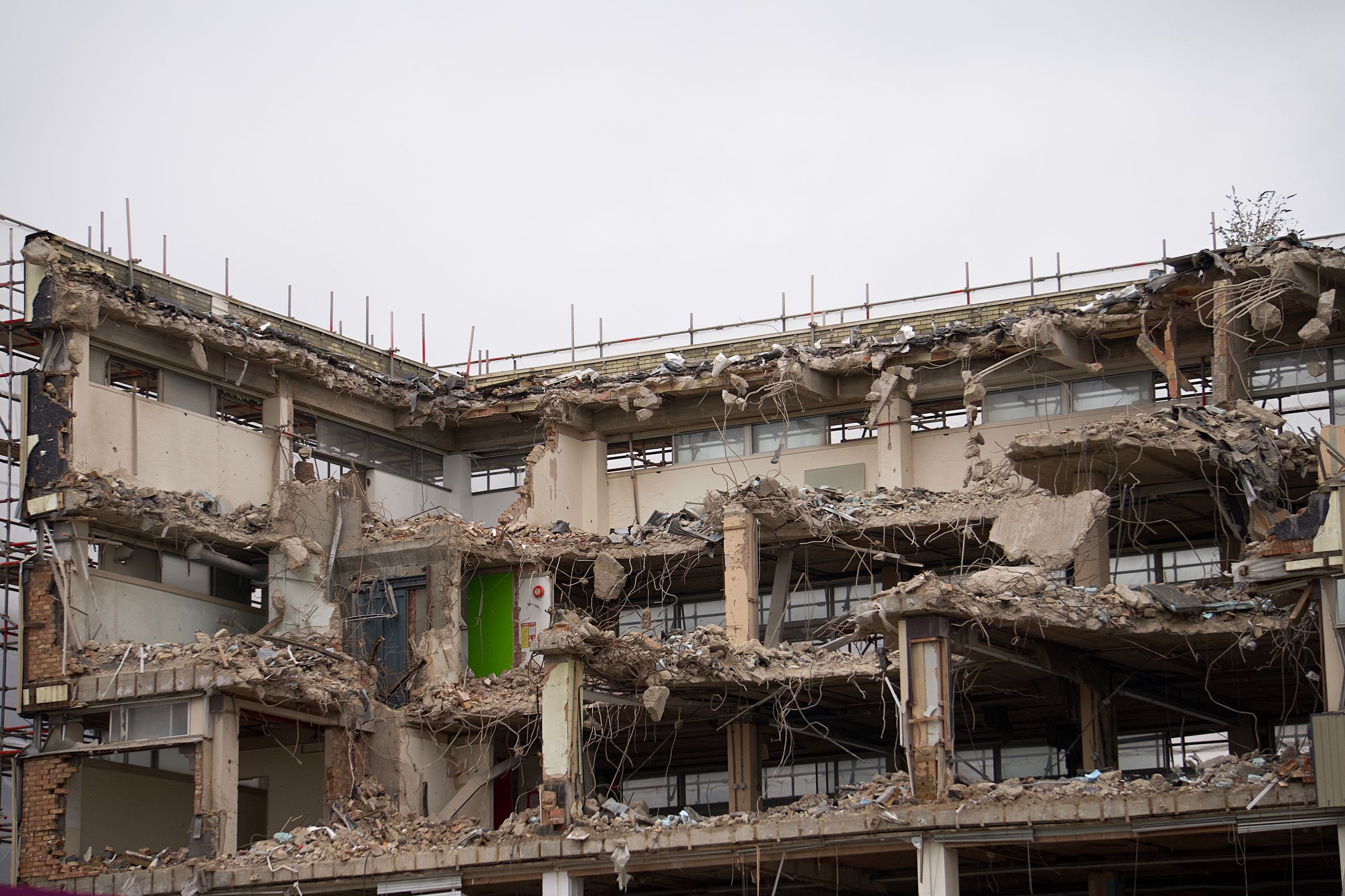 A building being torn down. The urge to level everything and start clean is real, and almost always pricier than it looks.