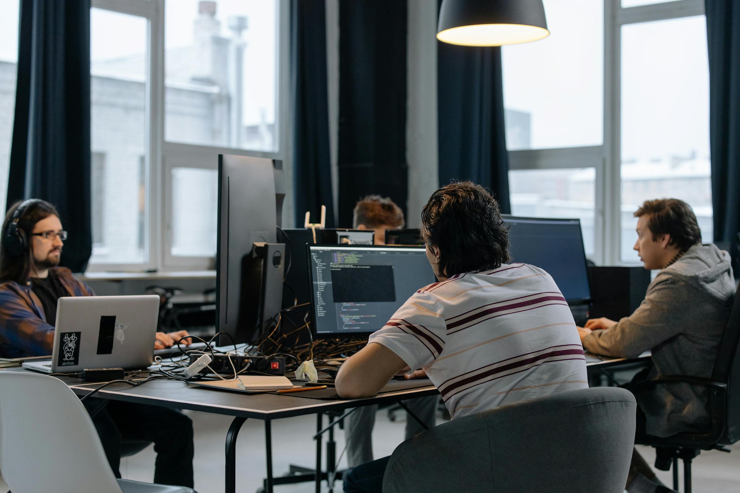 Engineering team collaborating on a project — how you hire shapes how they operate